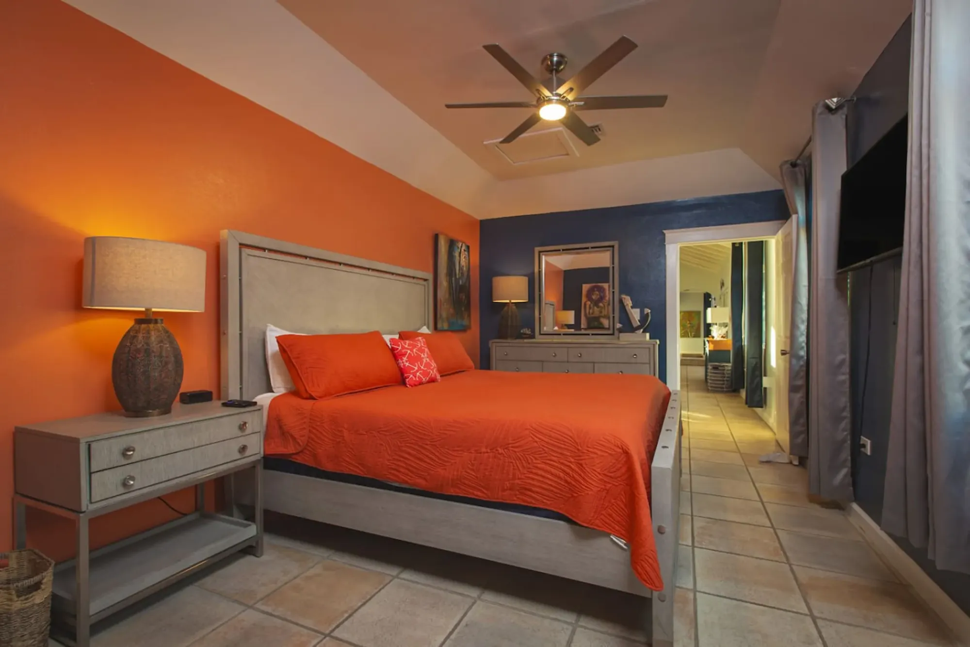 A bedroom with a warm accent wall