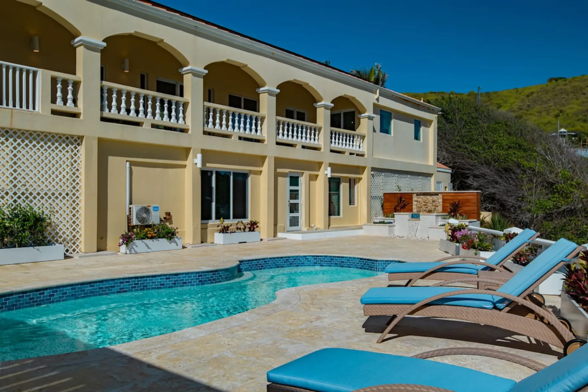 The villa facade and pool in daylight