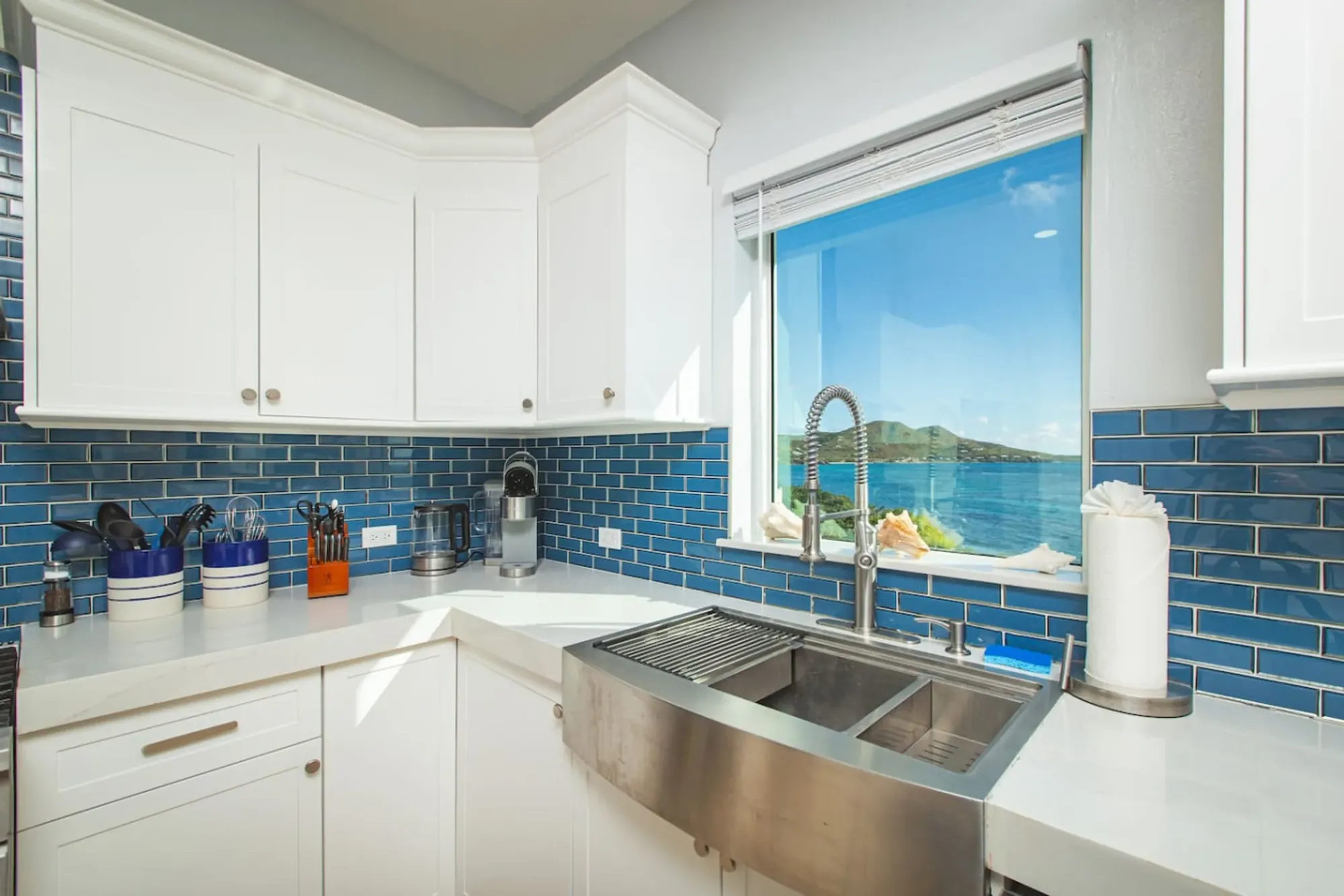 The chef's kitchen and its sea-view window. Long, easy dinners at home are one of the pleasures of a summer or fall week.