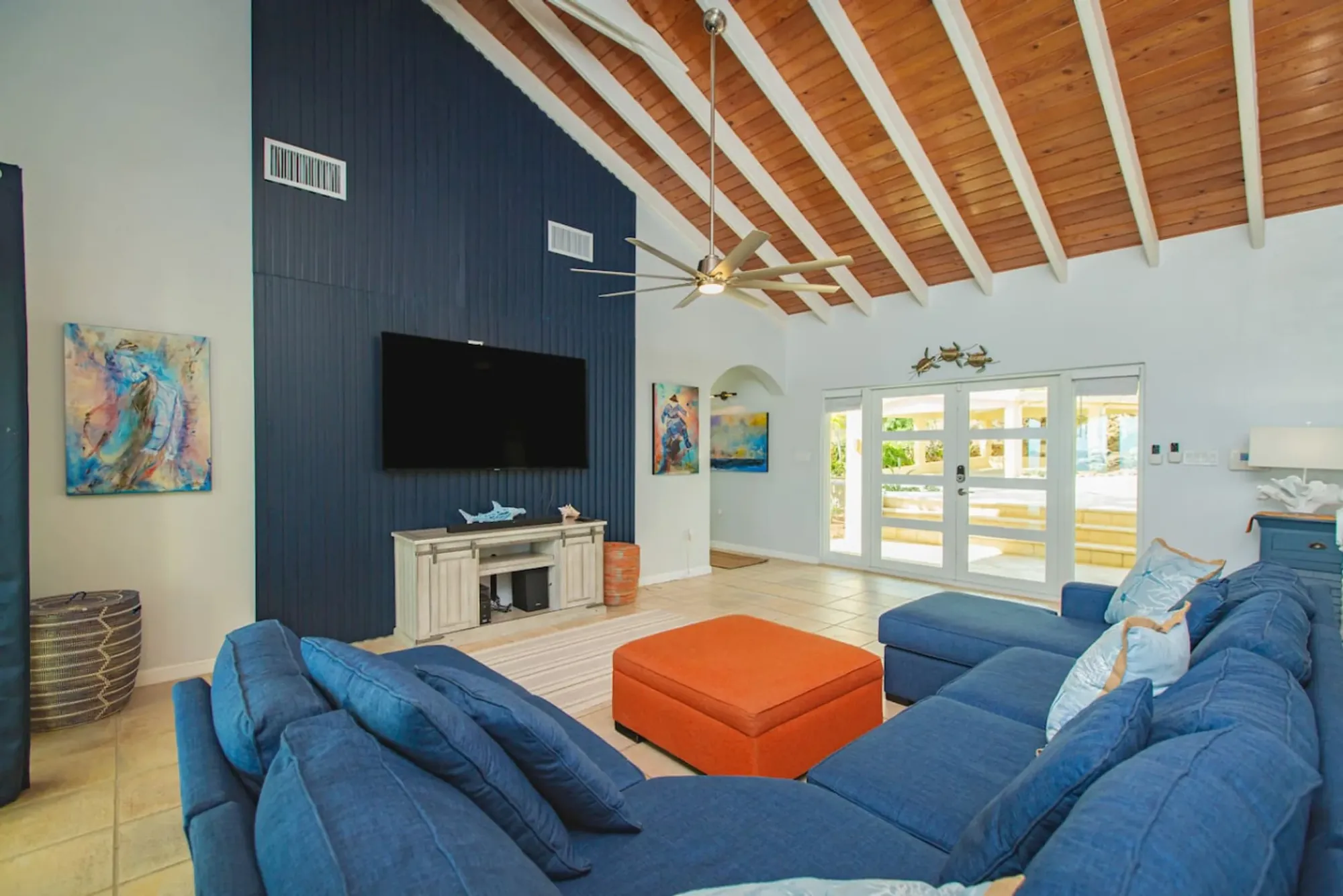 Living room with a navy accent wall and French doors