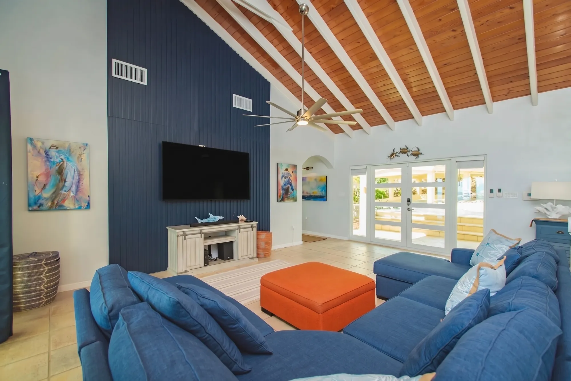 Living room with a navy accent wall and French doors