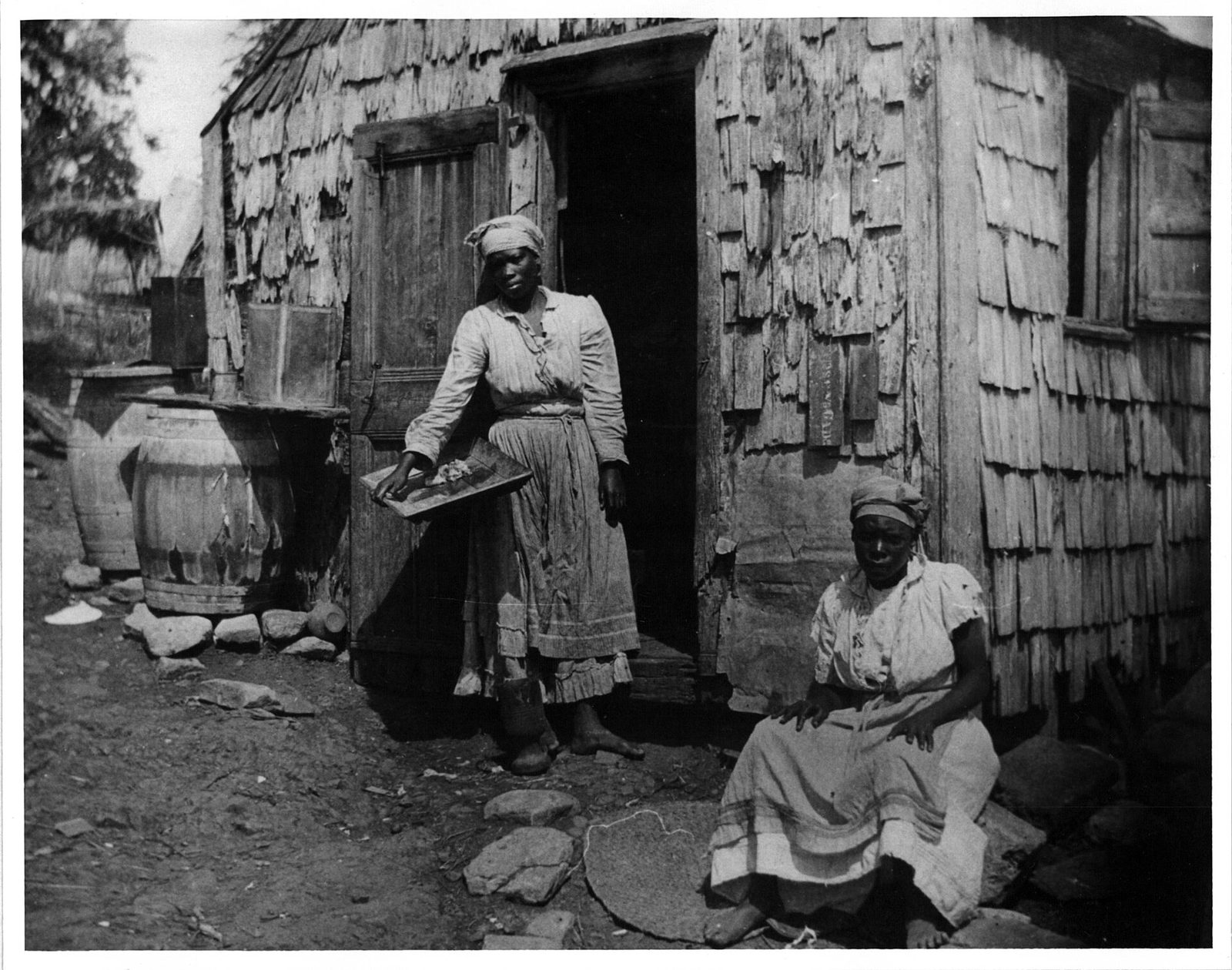 Two women in front of a house at St. Croix (9468858855)