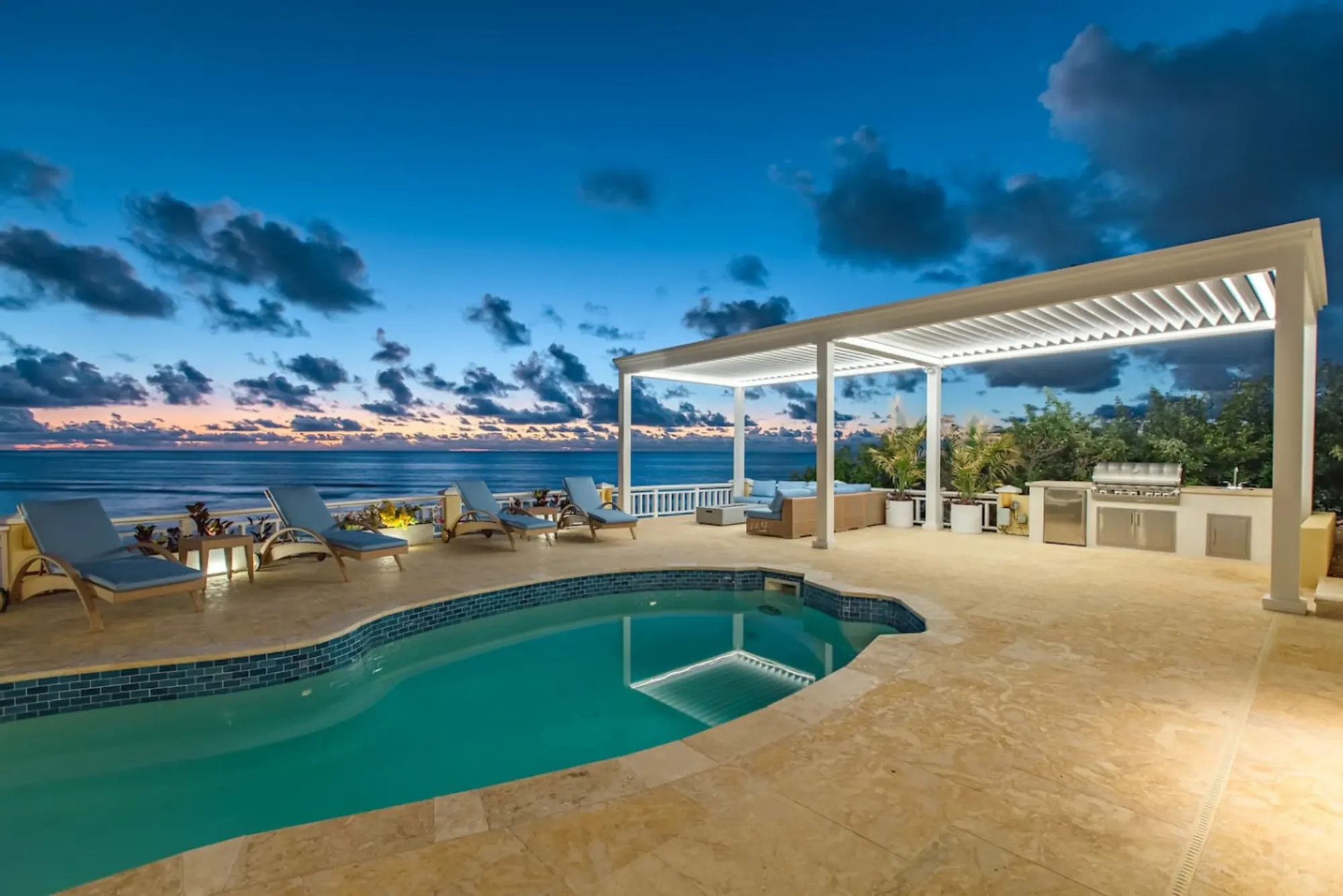 The private pool and covered pergola at sunset