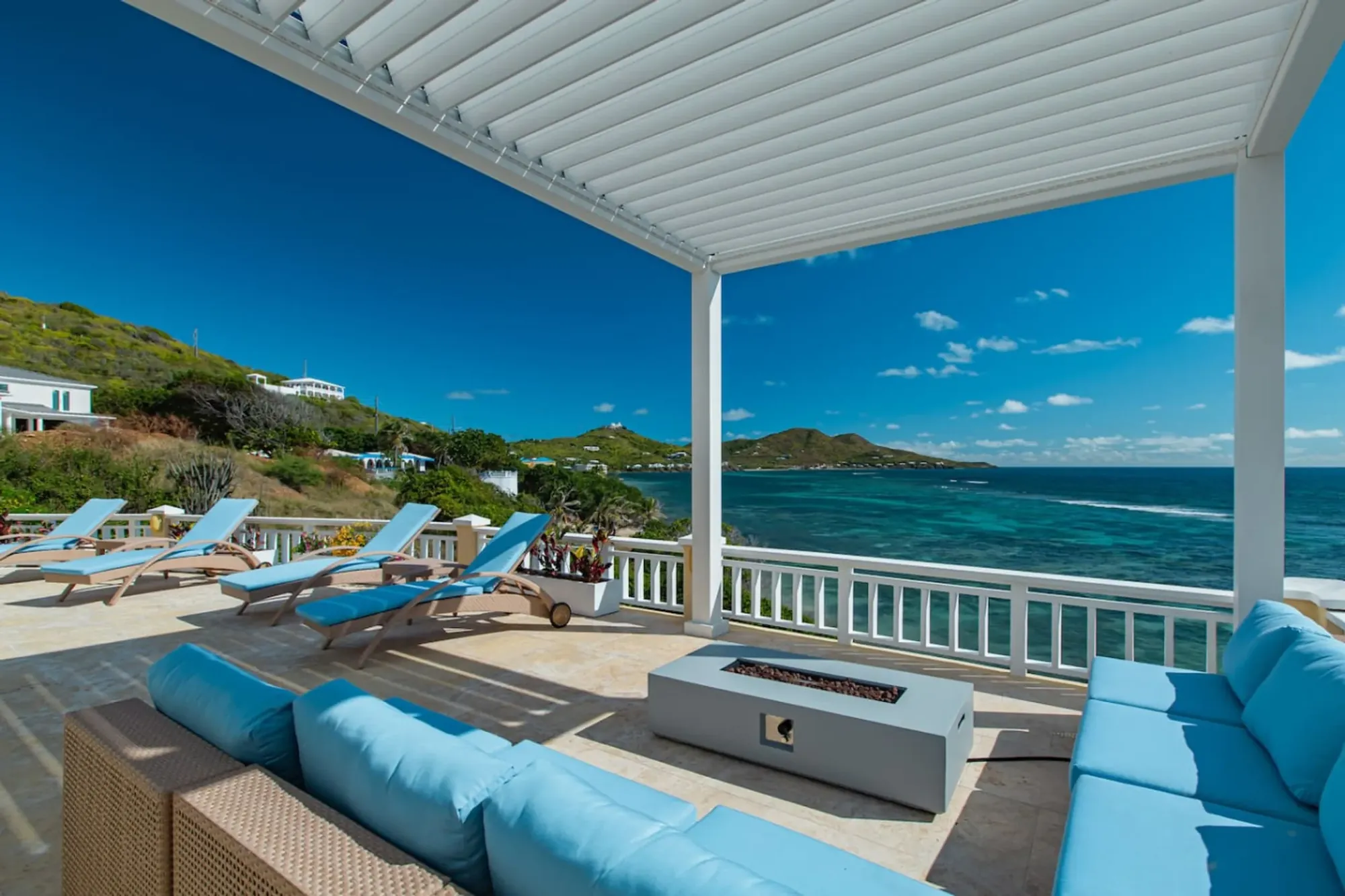 Covered patio with a fire table and an ocean view