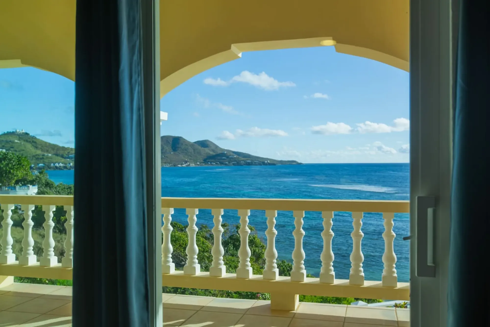 The sea framed by an archway and curtains